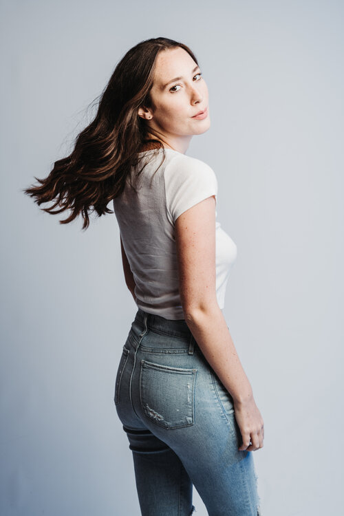 Brunette model with white shirt and blue jeans